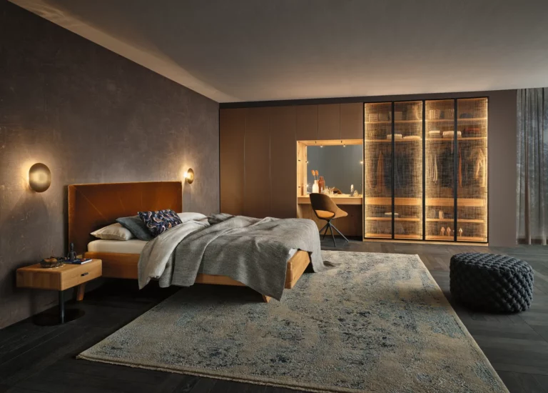 Anrei Ruum Schlafzimmer mit Holzrahmenbett und beleuchtetem Kleiderschrank.