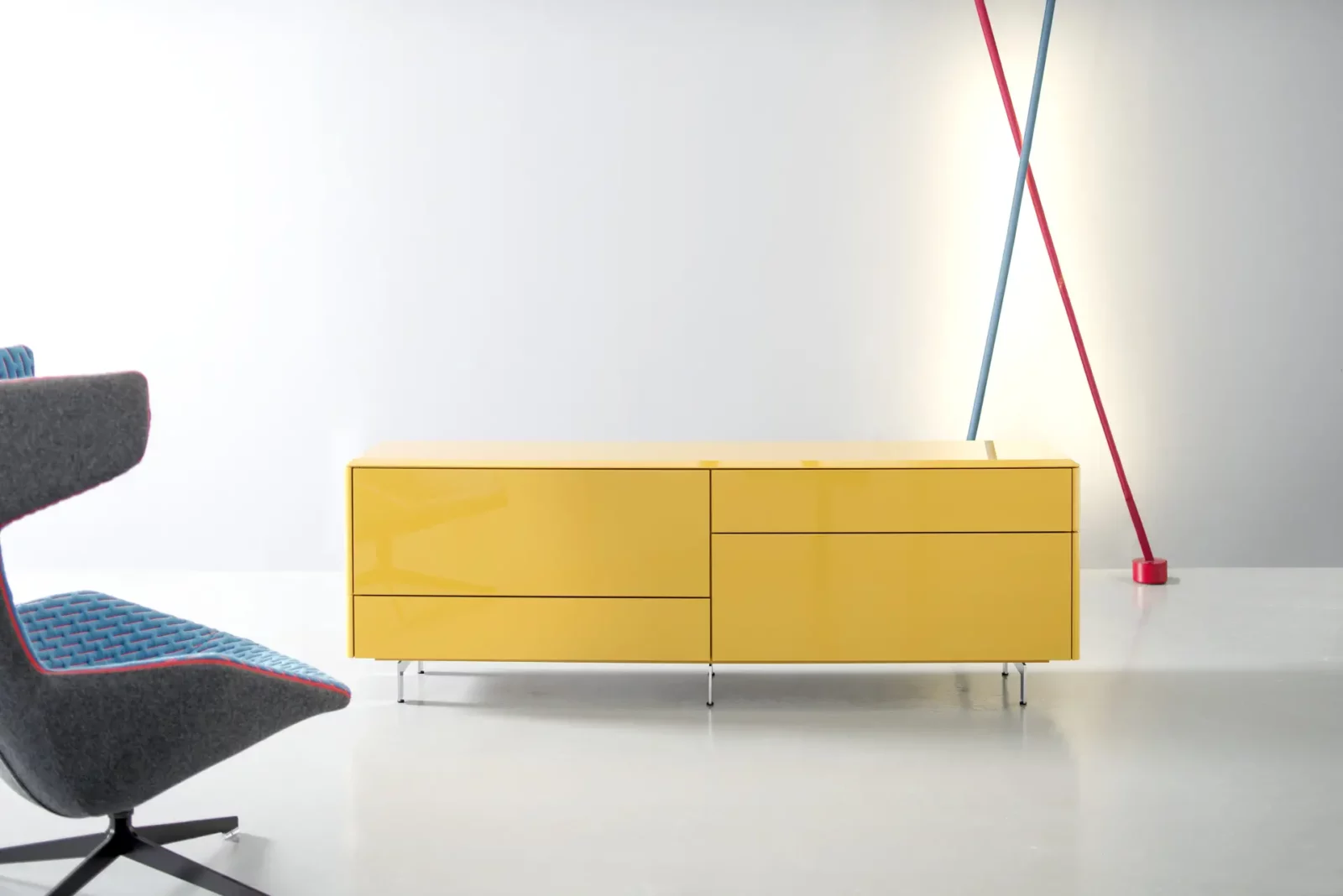 Gelbes Sideboard Gaya 041 mit Hochglanzoberfläche und schlanken Metallfüßen.